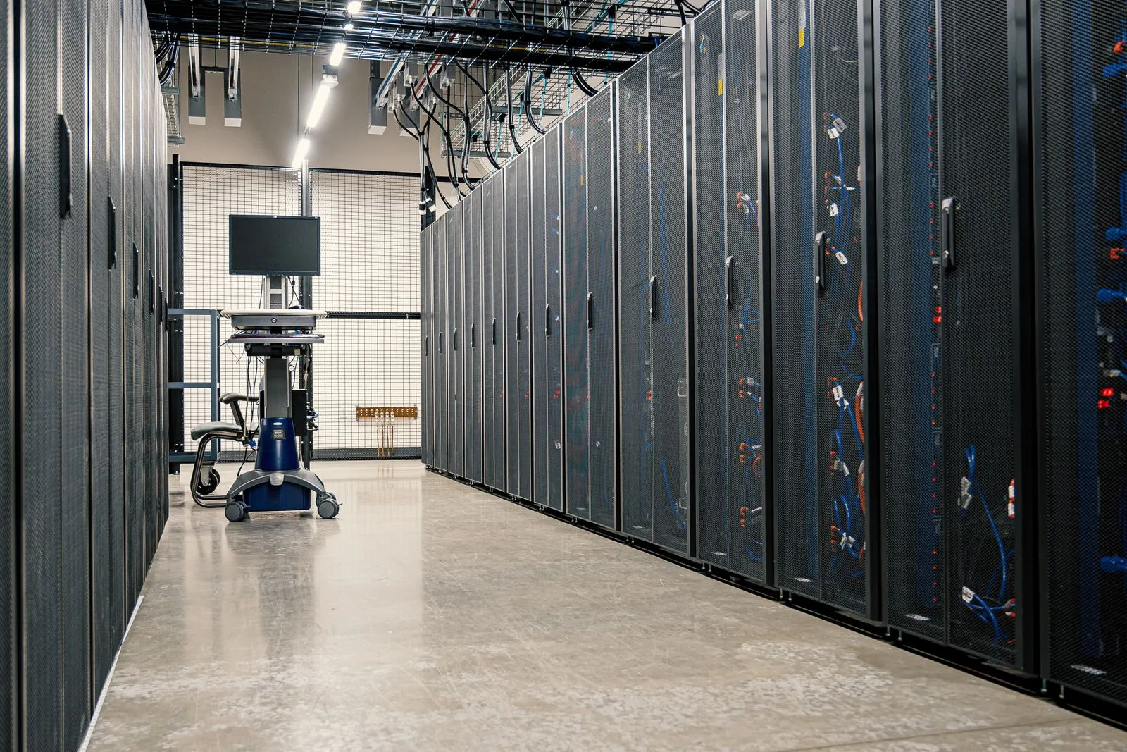 Rows of server racks along a data center corridor